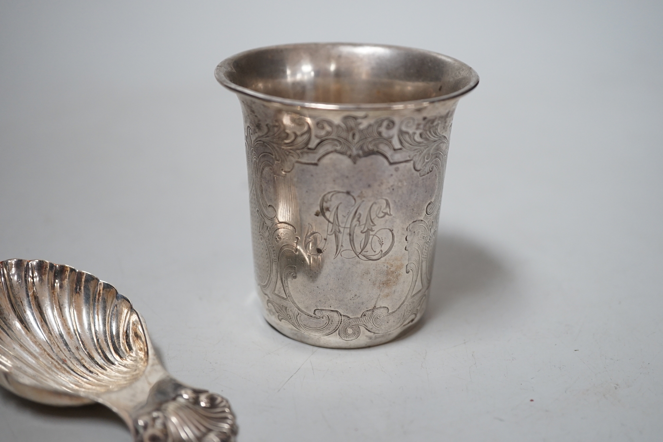 A Continental white metal tumbler cup, 66mm and a Mappin & Webb plated caddy spoon